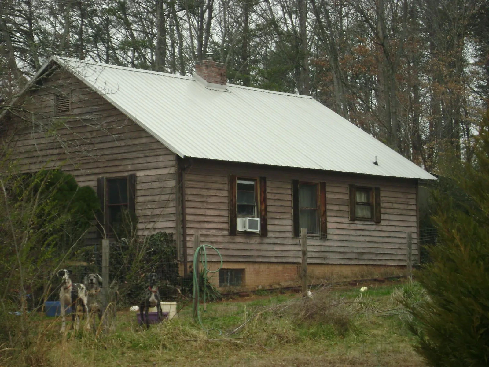 White metal roof on an old wood sided farmhouse, from a Metal Roof Installation job in Finley